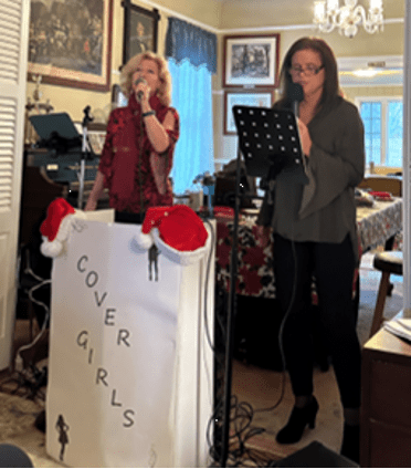 Kathy Martin and Mary Damato smile together before their 2022 holiday performance for UCHS.